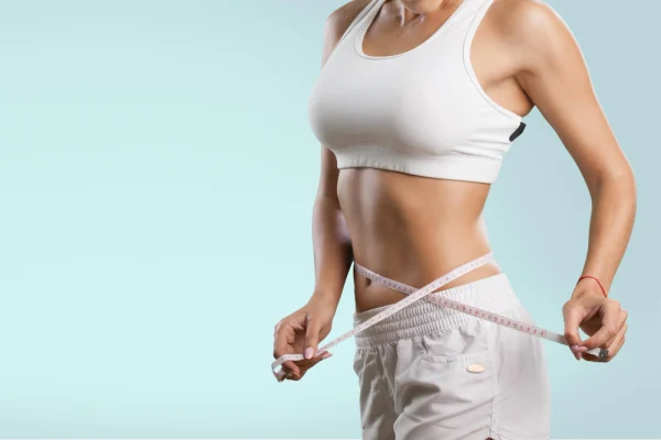 Young woman showing waist. weight loss concept
